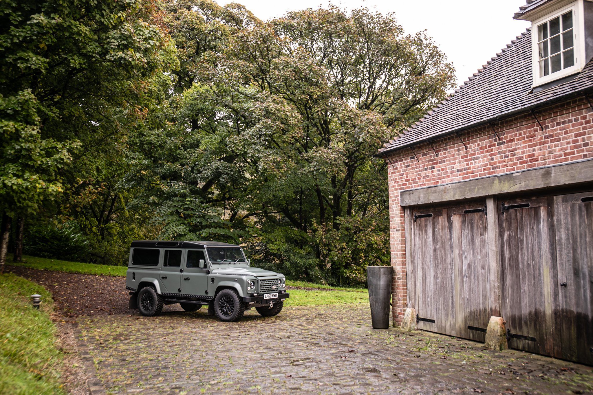 2011 Land Rover Restomod shot on a cobble road
